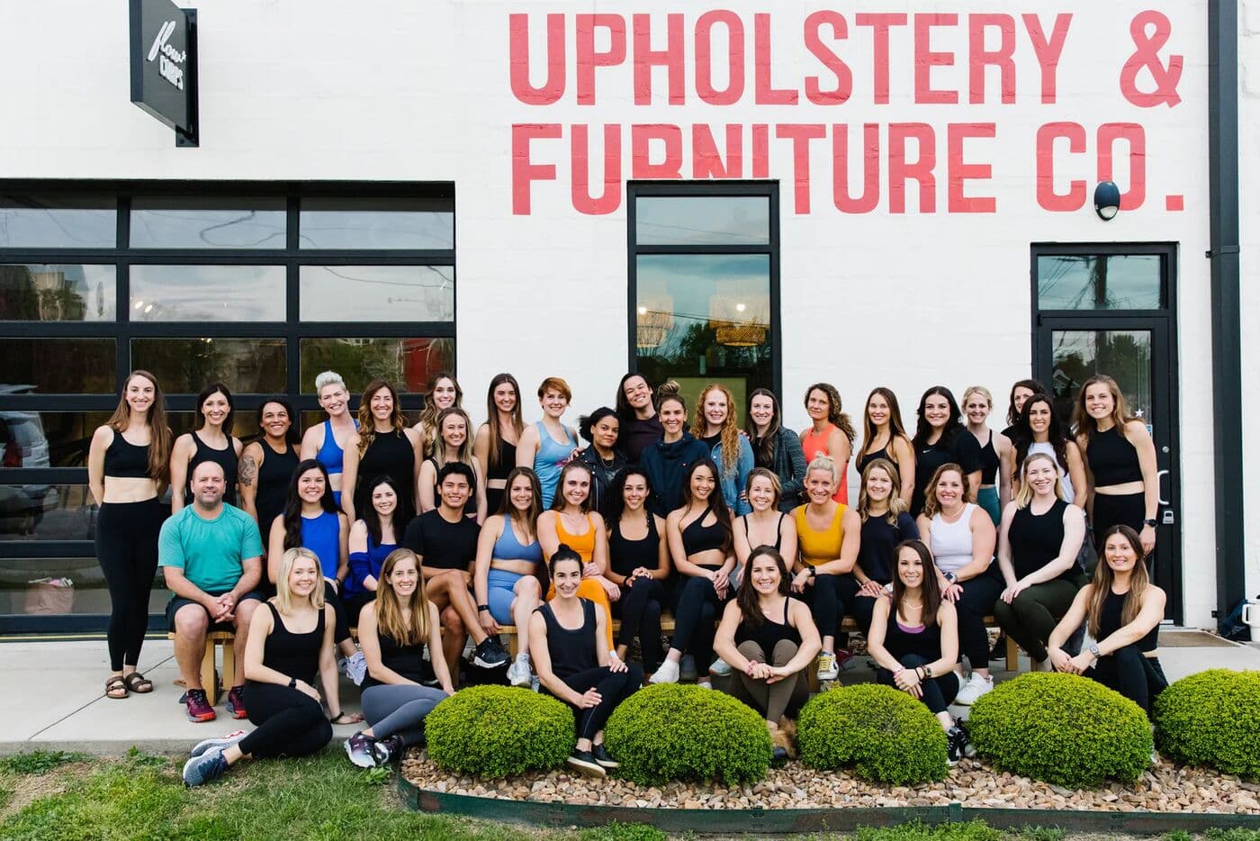 The FlowCorps team posing for a group photo outside a studio