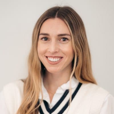 Alexa Barbaresi smiling in a white sweater