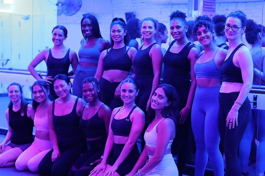 The Barre Code River North team posing together in the studio