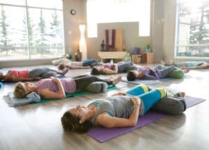 A restorative yoga class resting on mats at Milestone Wellness Center